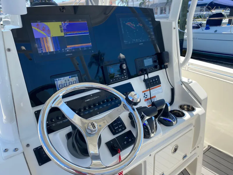 Slide: The Image of 2022 Cobia 301 Center Console helm with advanced navigation and control systems. - 5
