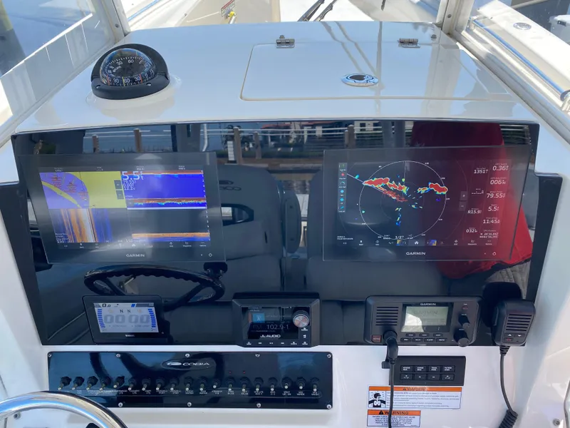 Slide: The Image of 2022 Cobia 301 Center Console dashboard with navigation screens and controls. - 7