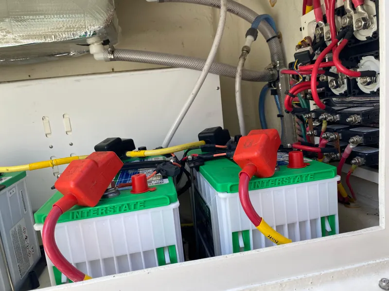 Slide: The Image of Batteries and wiring inside a 2022 Cobia 301 Center Console boat. - 9