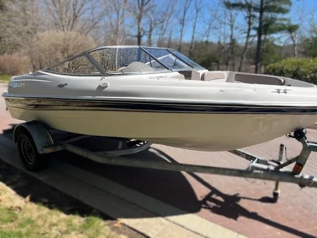 Slide: The Image of 2002 Four Winns 170 Horizon boat on trailer, parked outdoors. - 0