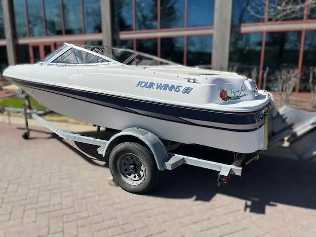 Slide: The Image of 2002 Four Winns 170 Horizon boat on trailer, parked outdoors. - 2