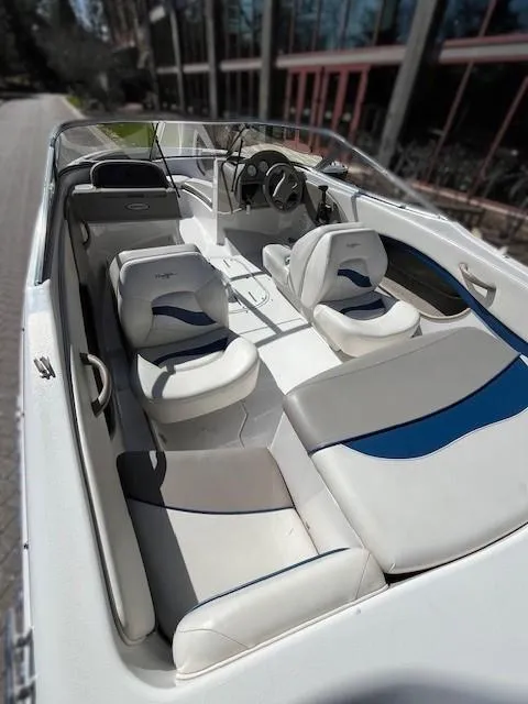 Slide: The Image of 2002 Four Winns 170 Horizon boat interior with white and blue seating. - 3