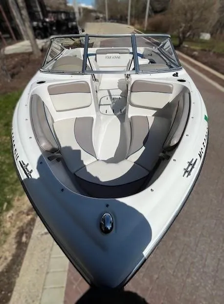 Slide: The Image of 2002 Four Winns 170 Horizon boat with white and gray interior, docked on a sunny day. - 4