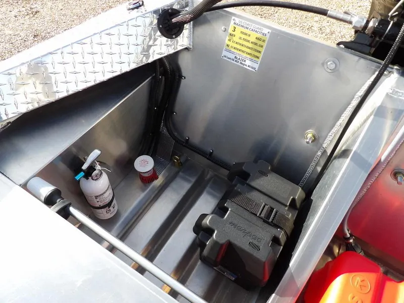 Slide: The Image of Interior of 2025 Blazer 1752 SS boat showing storage compartment with fire extinguisher and battery. - 12