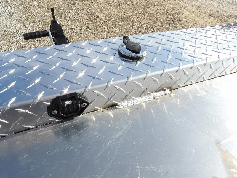 Slide: The Image of Diamond plate surface on 2025 Blazer 1752 SS, featuring a fuel cap and connector. - 21