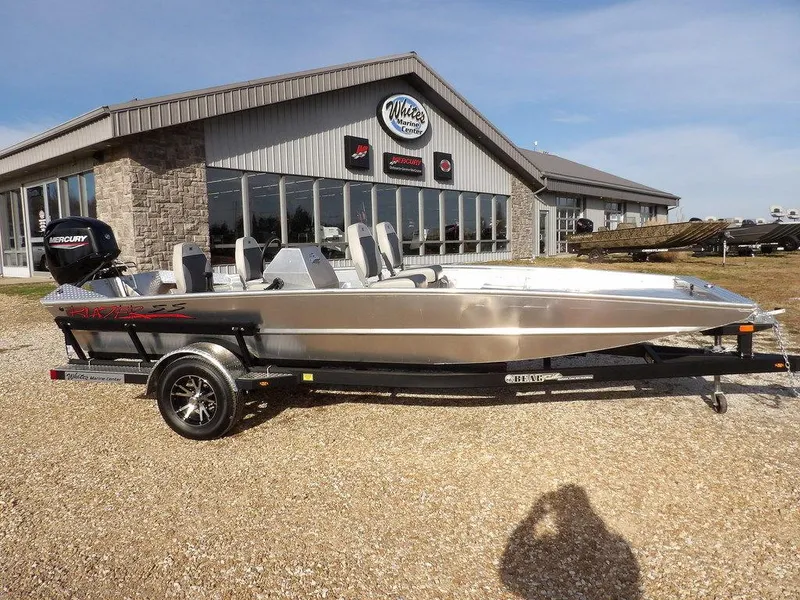 Slide: The Image of 2025 Blazer 1752 SS boat on trailer outside dealership, featuring sleek design and Mercury engine. - 32