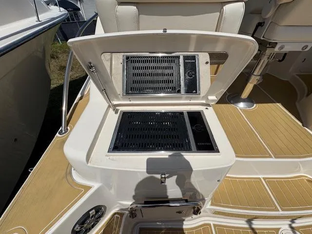 Slide: The Image of 2022 Grady-White Express 370 boat grill on deck, open lid, teak flooring. - 14
