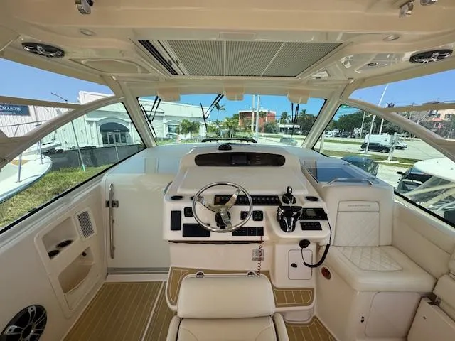 Slide: The Image of Interior of 2022 Grady-White Express 370 boat, featuring helm and seating area. - 16