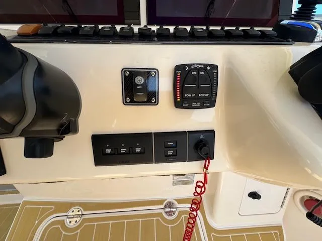Slide: The Image of Control panel of 2022 Grady-White Express 370 boat with switches and gauges. - 18