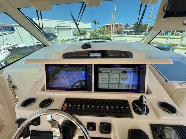 Slide: The Image of 2022 Grady-White Express 370 helm with dual navigation screens and control panel. - 24