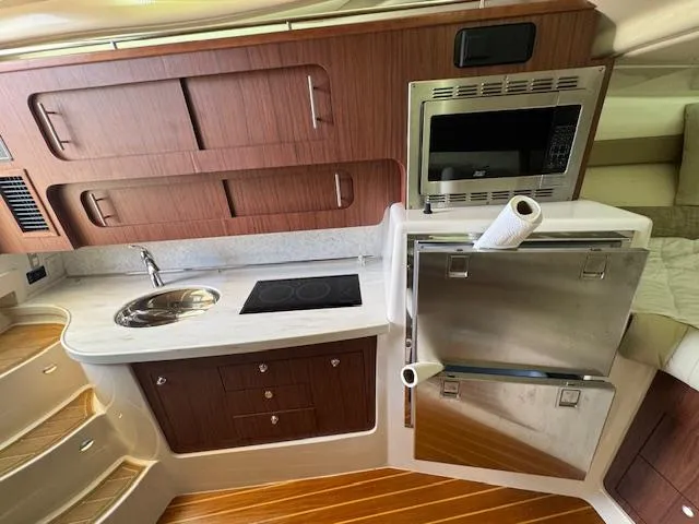 Slide: The Image of Luxurious 2022 Grady-White Express 370 yacht kitchen with modern appliances and wood cabinetry. - 33