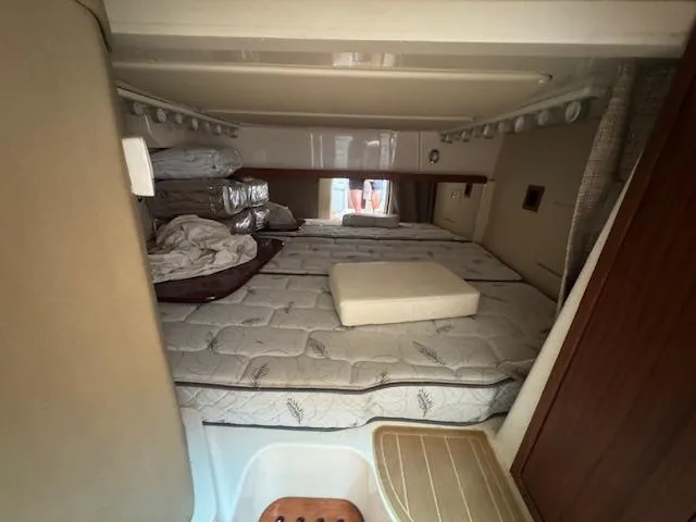 Slide: The Image of 2022 Grady-White Express 370 cabin interior with bedding and storage space. - 34