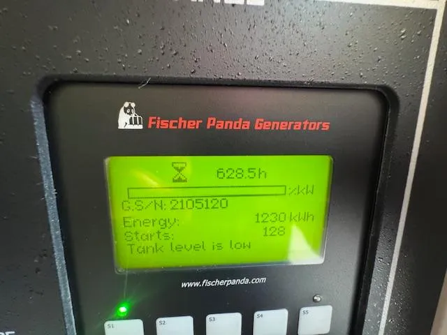 Slide: The Image of Fischer Panda generator display showing 628.5 hours, 1230 kWh energy, low tank level. Grady-White Express 370. - 35