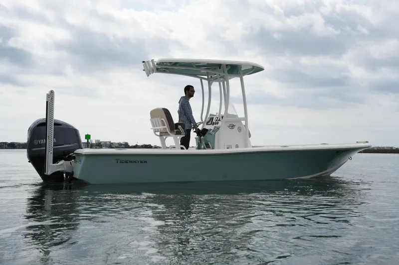 Slide: The Image of 2021 Tidewater 2210 Carolina Bay boat on calm water, side view. - 11