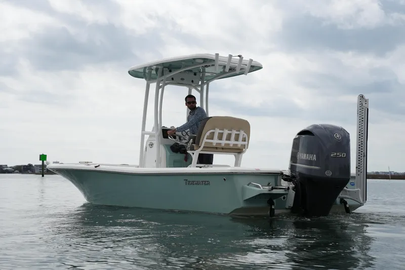 Slide: The Image of 2021 Tidewater 2210 Carolina Bay boat with Yamaha engine on calm water. - 12