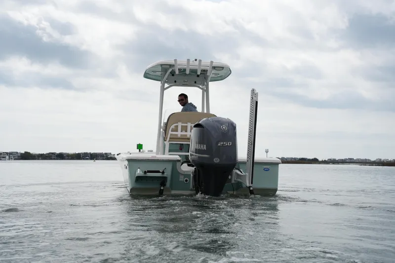 Slide: The Image of 2021 Tidewater 2210 Carolina Bay boat on calm water, rear view with Yamaha 250 engine. - 15