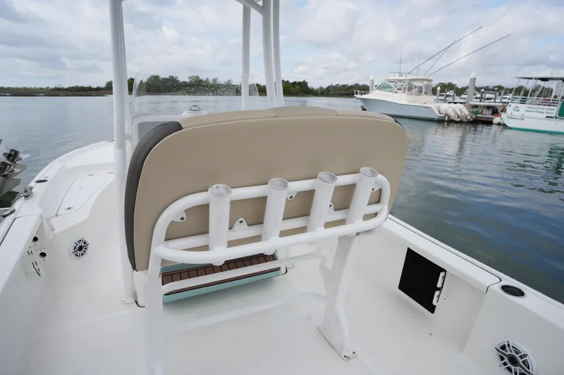 Slide: The Image of 2021 Tidewater 2210 Carolina Bay boat interior with rod holders, docked by the water. - 18