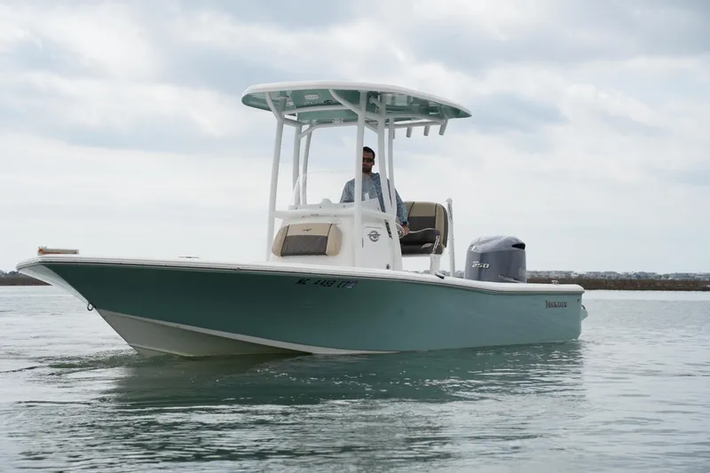 Slide: The Image of 2021 Tidewater 2210 Carolina Bay boat cruising on calm water. - 2