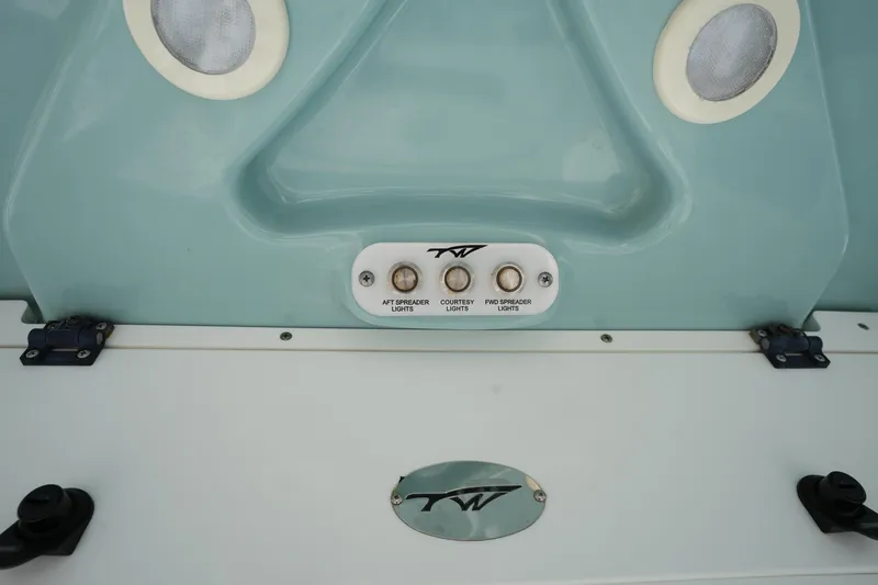 Slide: The Image of 2021 Tidewater 2210 Carolina Bay boat dashboard with control switches and logo. - 24