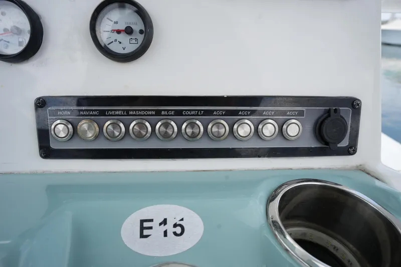 Slide: The Image of Control panel of 2021 Tidewater 2210 Carolina Bay boat with labeled switches and gauges. - 27