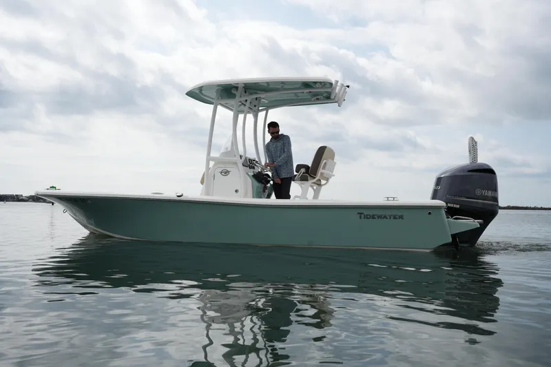 Slide: The Image of 2021 Tidewater 2210 Carolina Bay boat on calm water with overcast sky. - 3