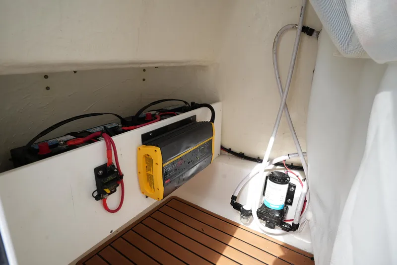 Slide: The Image of 2021 Tidewater 2210 Carolina Bay boat interior with battery setup and electrical components. - 30