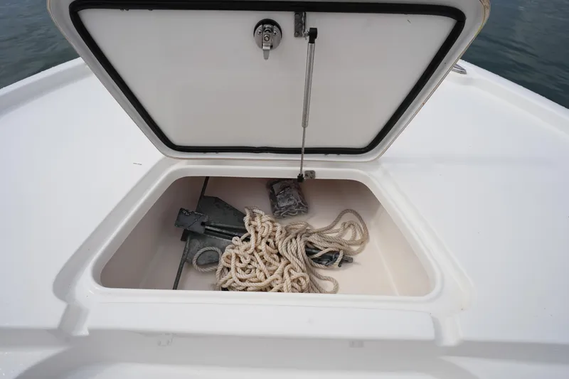 Slide: The Image of Open storage compartment on 2021 Tidewater 2210 Carolina Bay boat with rope and anchor. - 35