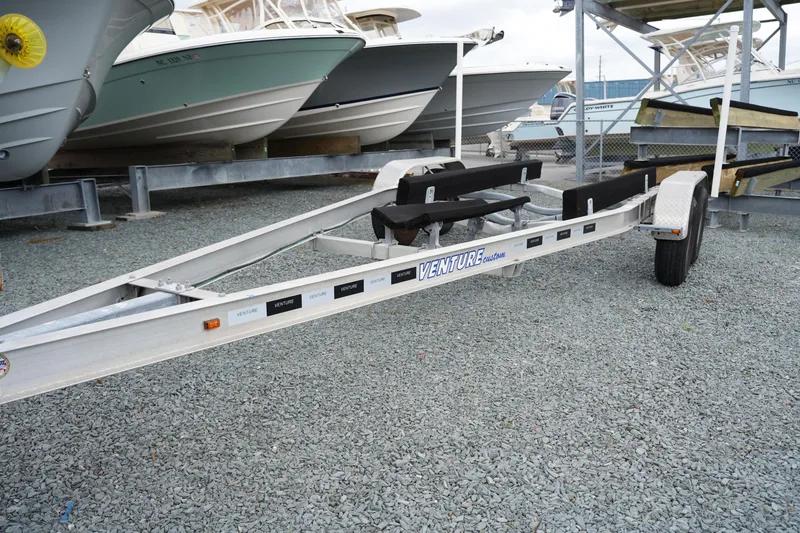 Slide: The Image of Boat trailer on gravel lot, near Tidewater 2210 Carolina Bay boats, 2021 model. - 39
