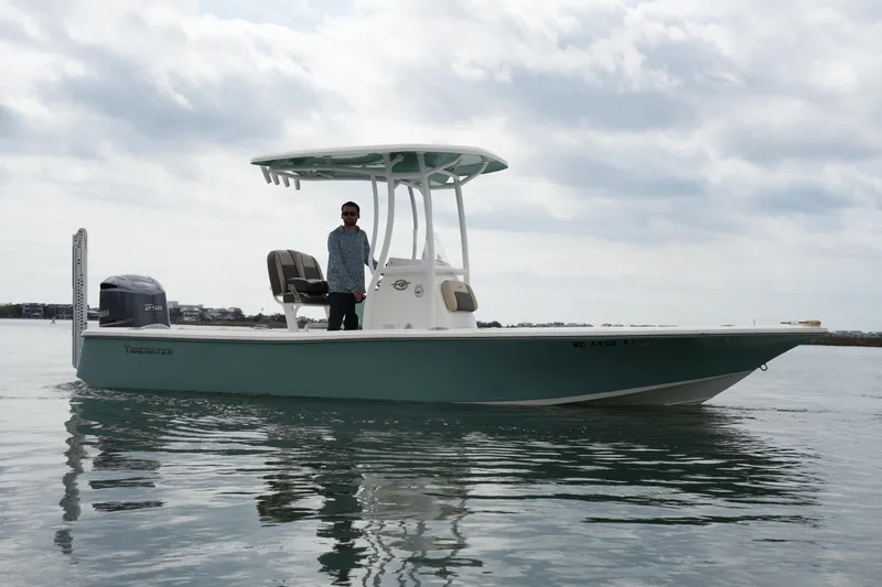 Slide: The Image of 2021 Tidewater 2210 Carolina Bay boat on calm water with overcast sky. - 4