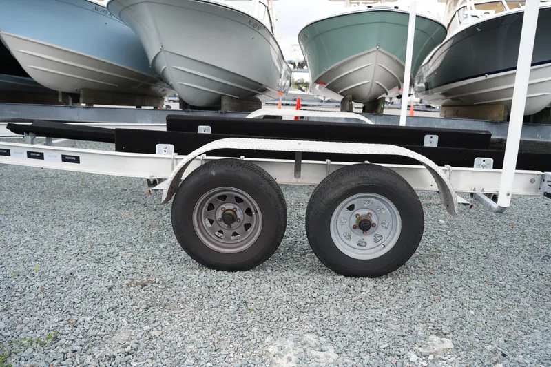 Slide: The Image of Trailer with dual wheels for 2021 Tidewater 2210 Carolina Bay boat on gravel. - 40