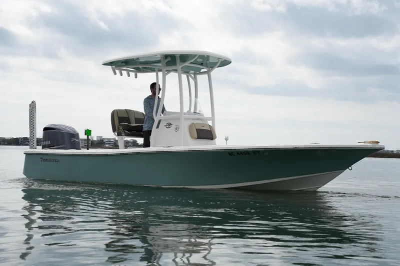 Slide: The Image of 2021 Tidewater 2210 Carolina Bay boat on calm water under cloudy sky. - 5