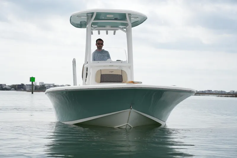 Slide: The Image of 2021 Tidewater 2210 Carolina Bay boat on calm water, front view. - 9
