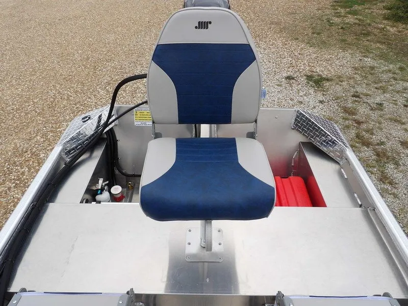 Slide: The Image of 2025 Blazer 1752 SC boat seat with blue and gray upholstery on a gravel surface. - 12
