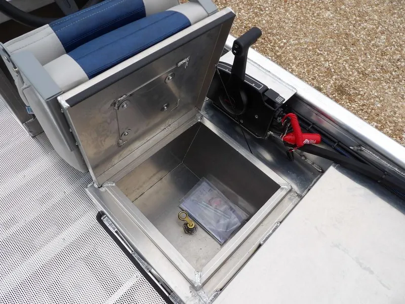 Slide: The Image of 2025 Blazer 1752 SC boat storage compartment with control lever and seat. - 19