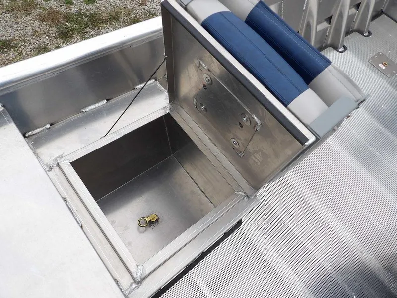 Slide: The Image of 2025 Blazer 1752 SC boat storage compartment with open lid and keys inside. - 21