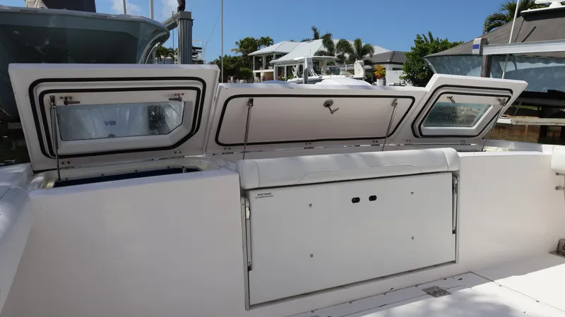 Slide: The Image of 2019 Everglades 435 Center Console boat with open storage compartments. - 11