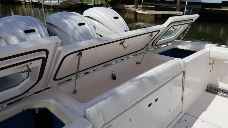 Slide: The Image of 2019 Everglades 435 Center Console boat with open storage compartments and powerful engines. - 12