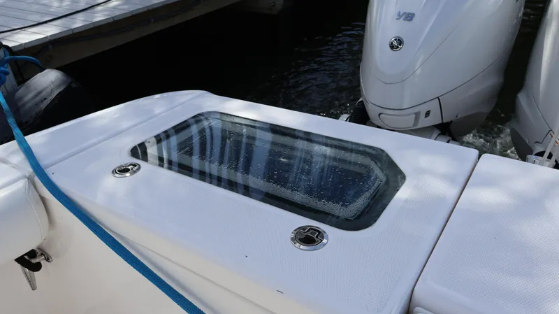 Slide: The Image of 2019 Everglades 435 Center Console boat with dual outboard engines and a livewell. - 13