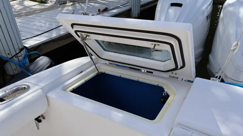 Slide: The Image of Open storage compartment on 2019 Everglades 435 Center Console boat. - 14