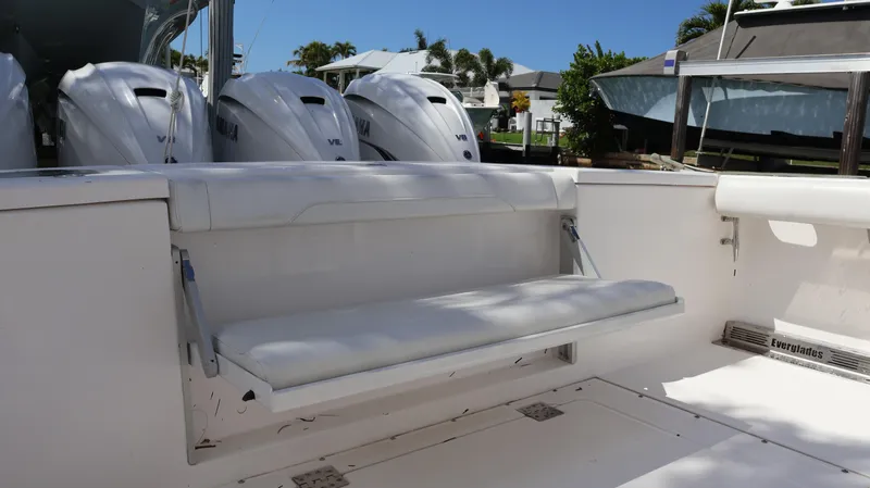 Slide: The Image of 2019 Everglades 435 Center Console boat with foldable seating and multiple outboard engines. - 15