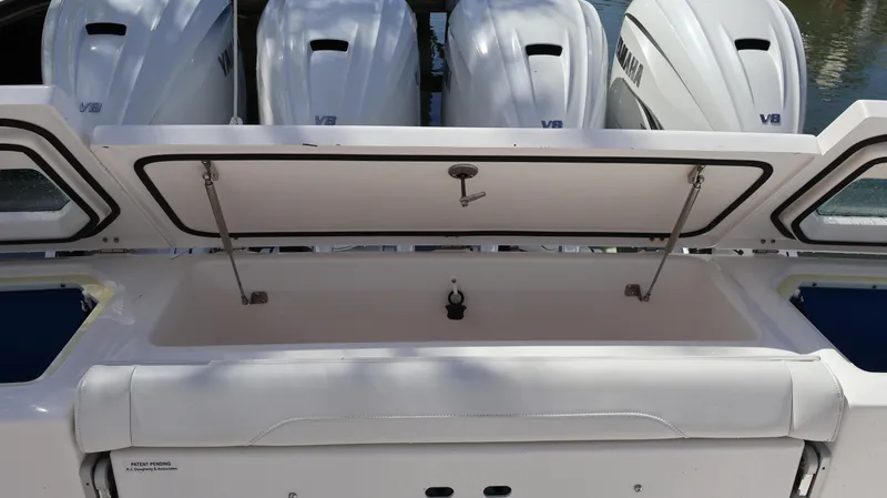 Slide: The Image of 2019 Everglades 435 Center Console with open storage compartment and Yamaha V8 engines. - 16