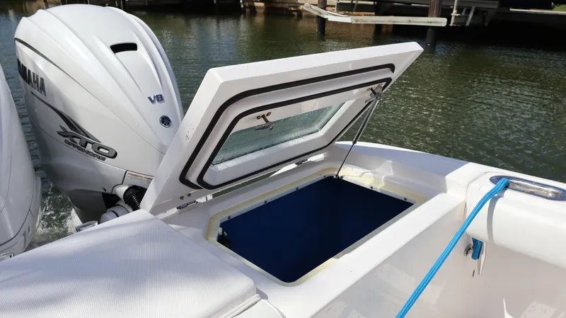Slide: The Image of 2019 Everglades 435 Center Console boat with Yamaha V8 engine and open storage compartment. - 17