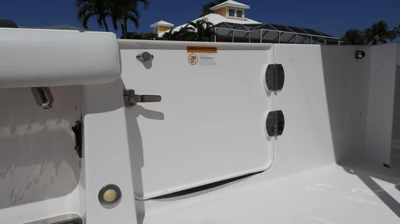 Slide: The Image of 2019 Everglades 435 Center Console boat interior with white panel and latch. - 19