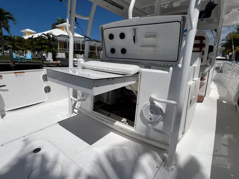 Slide: The Image of 2019 Everglades 435 Center Console boat interior with open storage compartments and seating. - 21