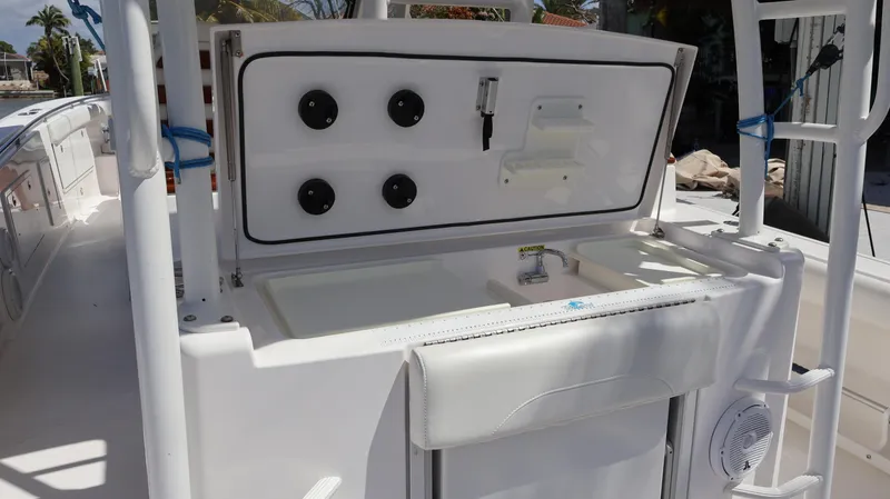 Slide: The Image of 2019 Everglades 435 Center Console boat interior with open storage compartment. - 27