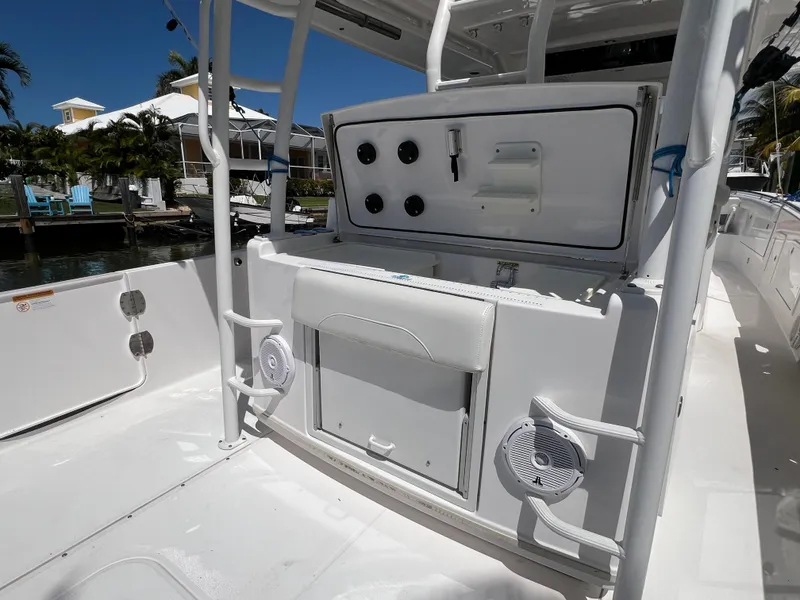 Slide: The Image of 2019 Everglades 435 Center Console boat interior with storage and speakers. - 28