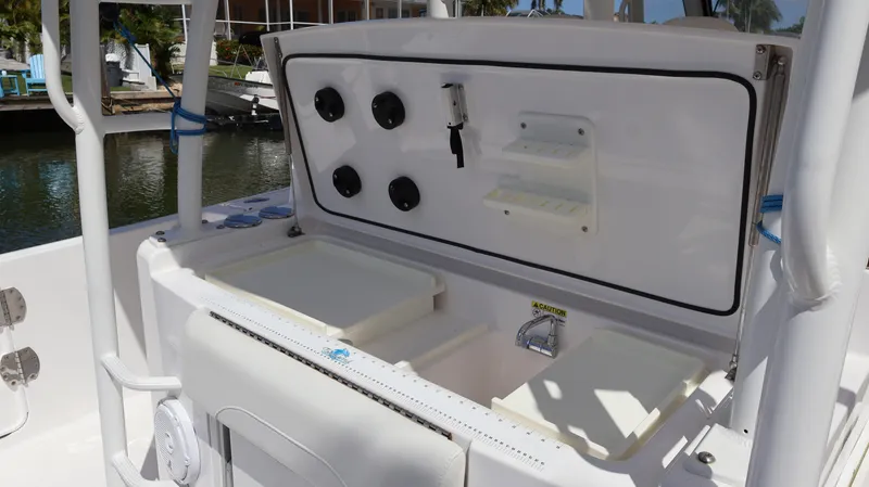 Slide: The Image of 2019 Everglades 435 Center Console boat with open storage compartments and control panel. - 29