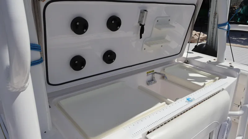 Slide: The Image of 2019 Everglades 435 Center Console boat with fishing rod holders and sink station. - 30