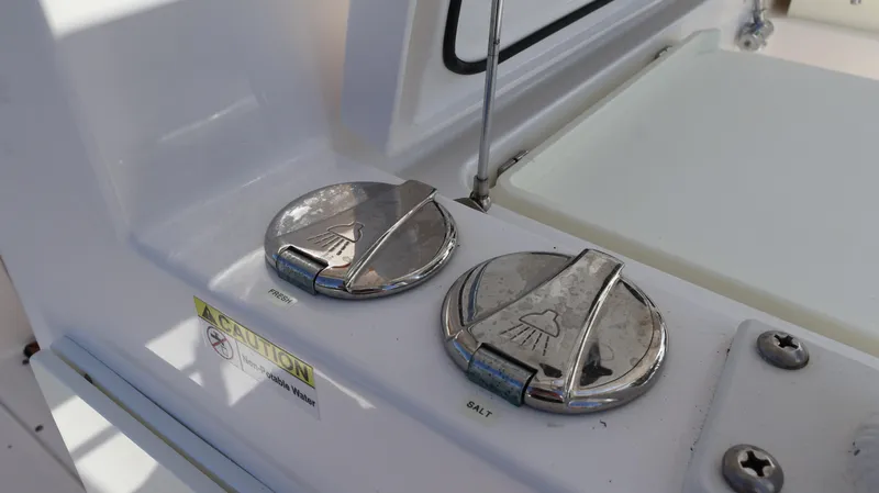 Slide: The Image of 2019 Everglades 435 Center Console boat fuel and water caps. - 32