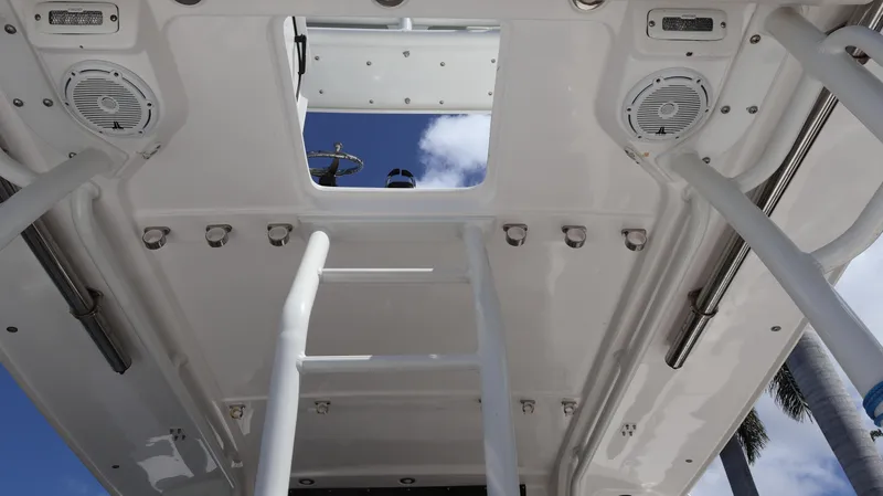 Slide: The Image of 2019 Everglades 435 Center Console boat interior with ladder and speakers, viewed from below. - 36
